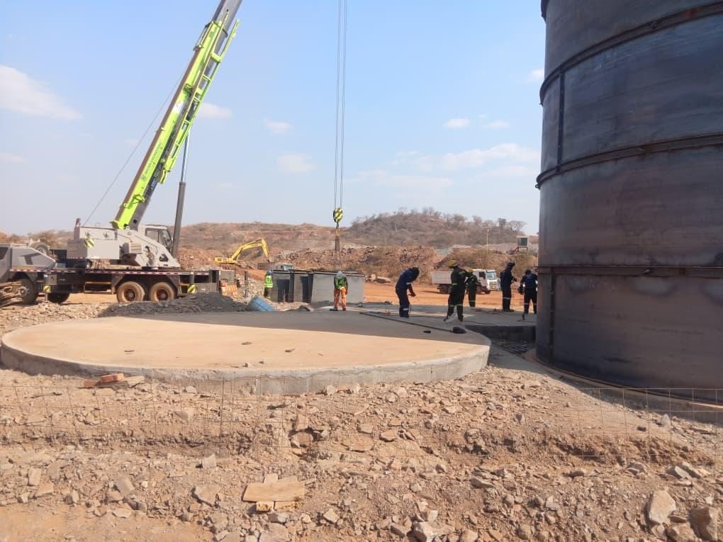 Crane and team installing tank sections