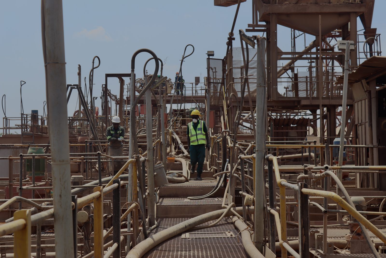 Team members walking along the plant walkways