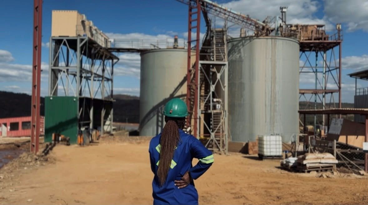 A Magaya Mining team member looks towards the leach tanks and conveyor at Amatola